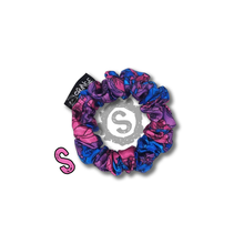 Load image into Gallery viewer, A small colourful scrunchie. A rose pattern in the colours of the Bisexual pride flag. Blue, pink and purple. Approximately 8cm in Diameter.