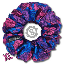 Load image into Gallery viewer, An extra large colourful scrunchie. A rose pattern in the colours of the Bisexual pride flag. Blue, pink and purple. Approximately 15cm in Diameter.
