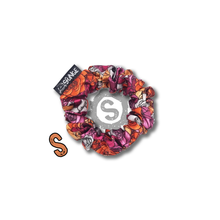 Load image into Gallery viewer, A small colourful scrunchie. A rose pattern in the colours of the Lesbian pride flag. White, orange and pink. Approximately 8cm in Diameter.
