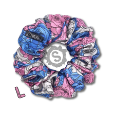 Load image into Gallery viewer, A large colourful scrunchie. A rose pattern in the colours of the trans pride flag. Blue, white and pink. Approximately 12cm in Diameter.