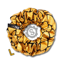 Load image into Gallery viewer, A large gold scrunchie, black satin covered in metallic golden scales. Approximately 12cm in Diameter.
