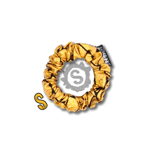 Load image into Gallery viewer, A small gold scrunchie, black satin covered in metallic golden scales. Approximately 8cm in Diameter.