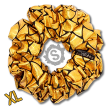 Load image into Gallery viewer, An extra large gold scrunchie, black satin covered in metallic golden scales. Approximately 15cm in Diameter.