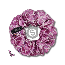 Load image into Gallery viewer, A large light pink scrunchie, covered in metallic pink scales. Approximately 12cm in Diameter.