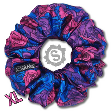 Load image into Gallery viewer, An extra large colourful scrunchie. A rose pattern in the colours of the Bisexual pride flag. Blue, pink and purple. Approximately 15cm in Diameter.
