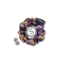 Load image into Gallery viewer, A small colourful scrunchie. A rose pattern in the colours of the Nonbinary pride flag. White, black, yellow and purple. Approximately 8cm in Diameter.
