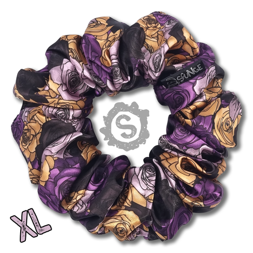 An extra large colourful scrunchie. A rose pattern in the colours of the Nonbinary pride flag. White, black, yellow and purple. Approximately 15cm in Diameter.