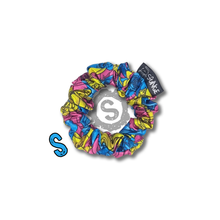 Load image into Gallery viewer, A small colourful scrunchie. A rose pattern in the colours of the Pansexual pride flag. Blue, pink and yellow. Approximately 8cm in Diameter.
