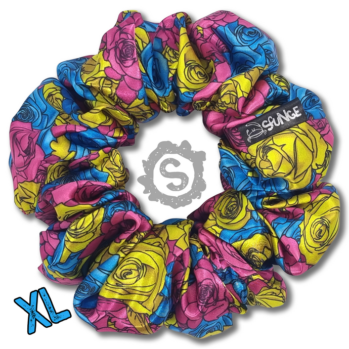 An extra large colourful scrunchie. A rose pattern in the colours of the Pansexual pride flag. Blue, pink and yellow. Approximately 15cm in Diameter.