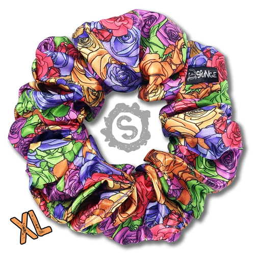 An extra large colourful scrunchie. A rose pattern in the colours of the pride flag. Red, orange, yellow, blue, green and purple. Approximately 15cm in Diameter.