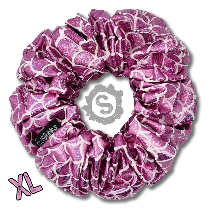 An extra large light pink scrunchie, covered in metallic pink scales. Approximately 15cm in Diameter.